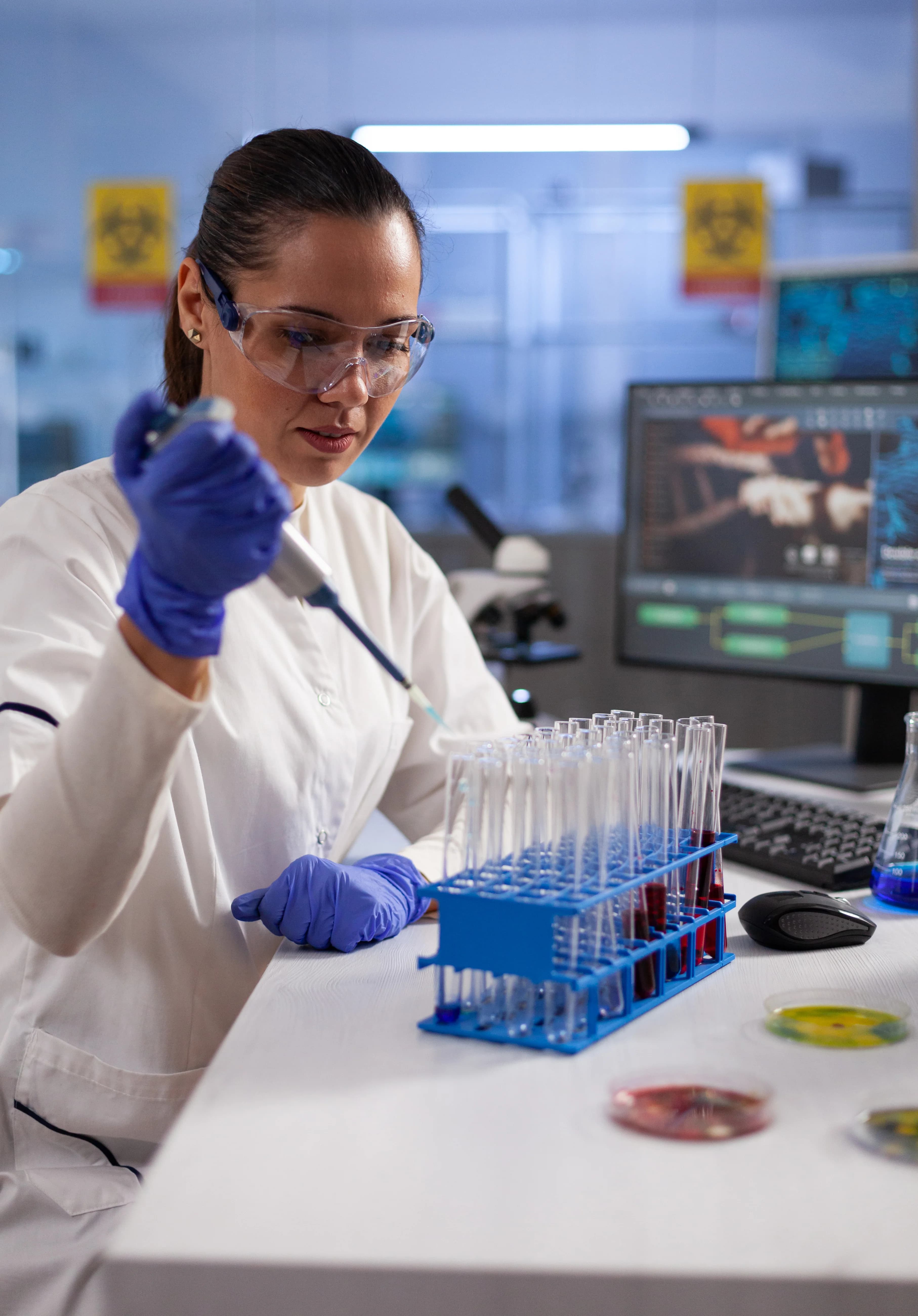 Chemist using a micropipette